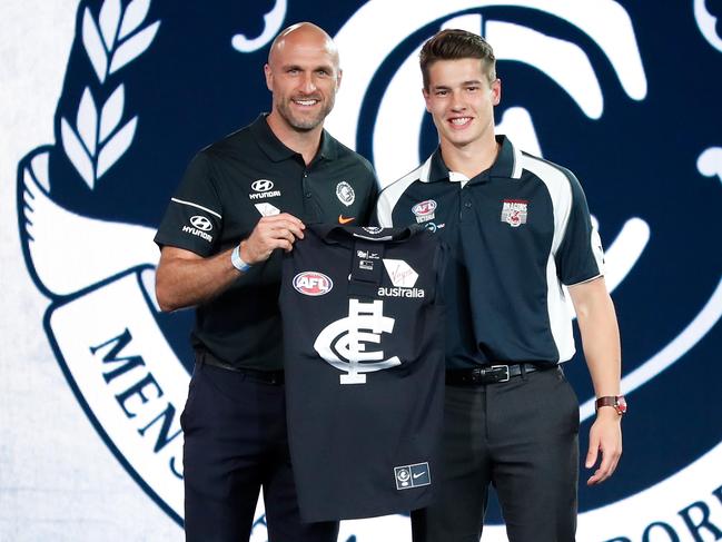 Chris Judd presents a Carlton jumper to Liam Stocker.