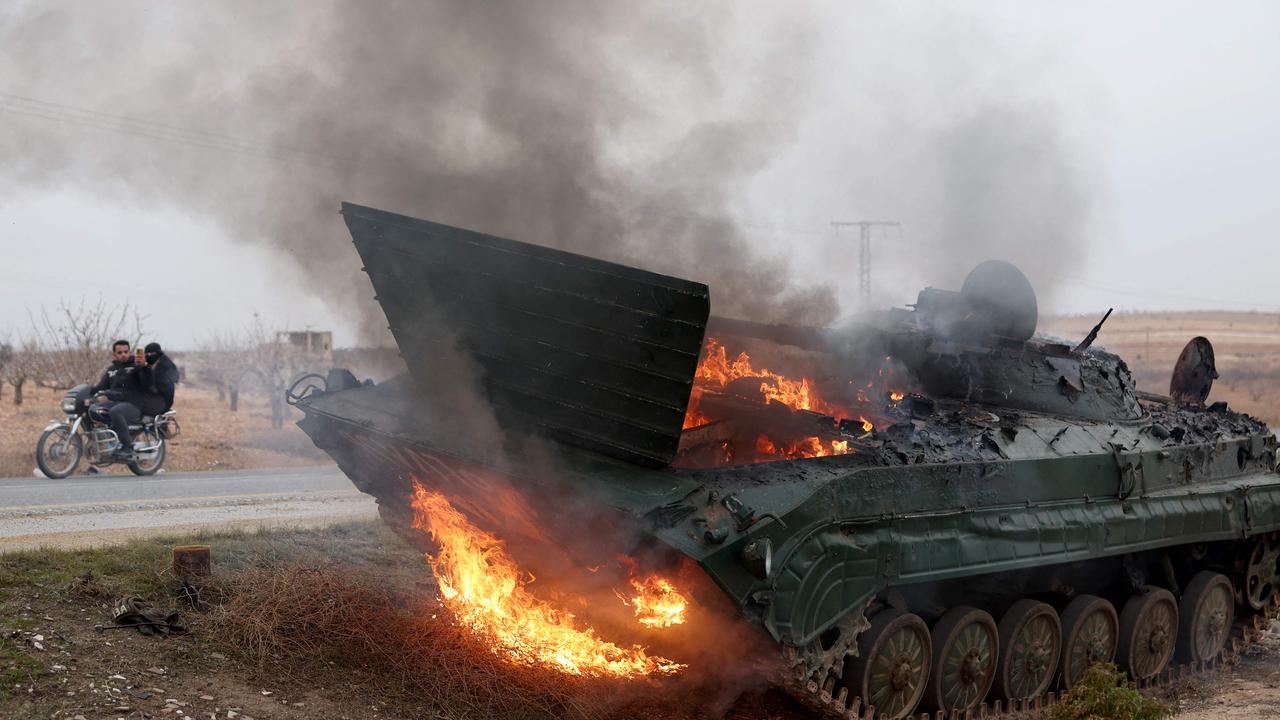 A military vehicle belonging to the Syrian regime forces and seized by anti government forces burns after it was hit by regime forces in the Hama governorate. Picture: Omar Haj Kadour/AFP