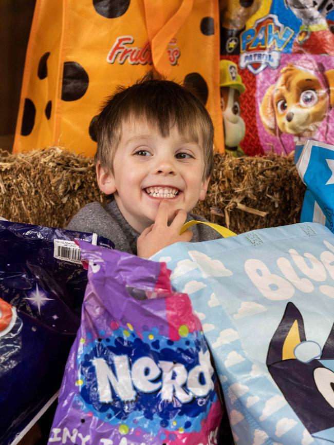 Alfie, 4, pondering his showbag choices ahead of the Royal Adelaide Show. Picture: NCA NewsWire / Kelly Barnes