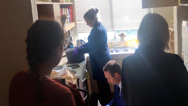 Federal Police officers searching Annika Smethurst's kitchen, including her oven, bin and cook books. Picture: Supplied