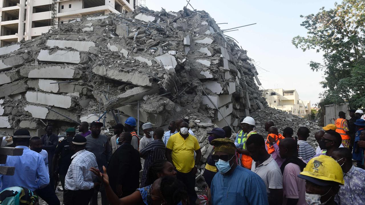 People stand to look at the rubble of a 21-storey building under construction that collapsed in the Ikoyi district of Lagos, on November 1, 2021. Picture: AFP