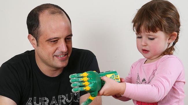 Emily Renfern, 4, shows off her new prosthetic limb with Melbourne engineer Mat Bowtell. Picture: Ian Currie