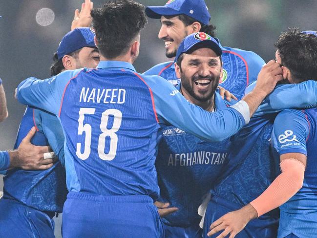 Afghanistan's players celebrate after winning the ICC Champions Trophy one-day international (ODI) cricket match between England and Afghanistan at the Gaddafi Stadium in Lahore on February 26, 2025. (Photo by Aamir QURESHI / AFP)