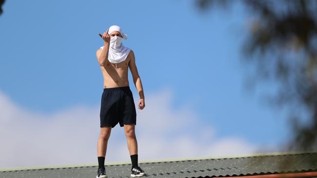 A youth on the roof on February 20, 2019. Picture: Alex Coppel.