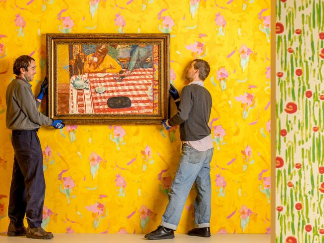 NGV installers Peter Narzisi and William Bennett with Bonnard’s Coffee (Le cafe) flanked by Mahdavi-designed wallpaper. Picture: Tim Carrafa