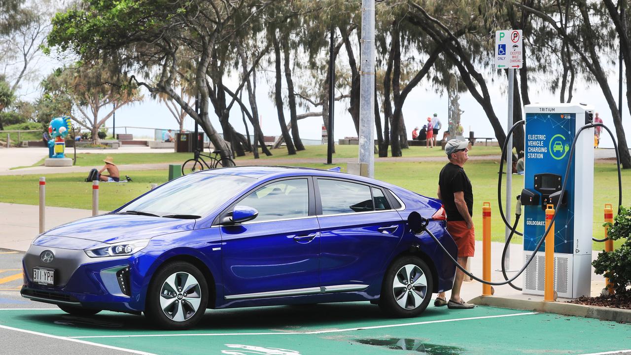 The shift to electric vehicles is seen as a key to cutting greenhouse gas emissions. Here a driver charges his electric car at a Gold Coast charging station. Picture: Scott Powick