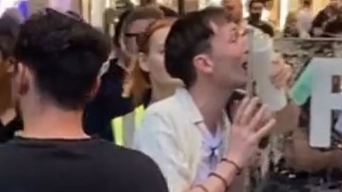 A man became stuck to a frozen billboard after he licked it with his tongue at Sydney’s Pitt St Mall. Picture: Reddit