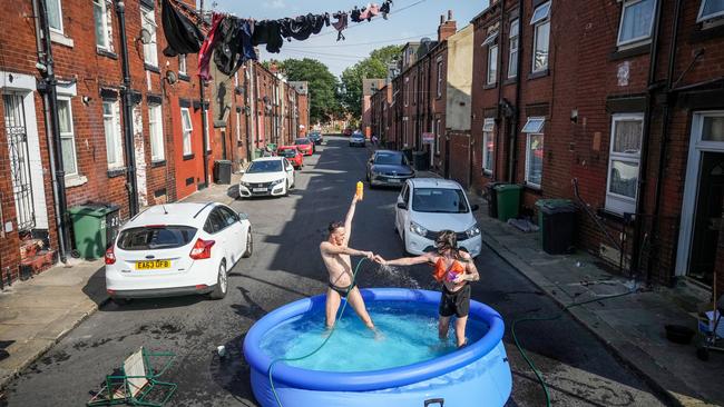 Residents take a dip in a paddling pool to cool off outside their home on July 19, 2022 in Leeds, United Kingdom when the mercury soared past 40C. Picture: Christopher Furlong/Getty Images