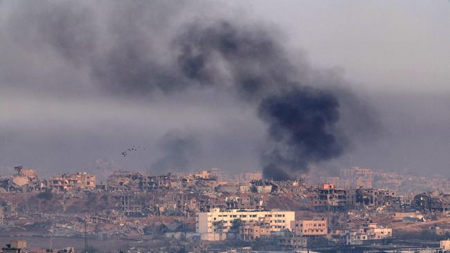 A picture taken from the Israeli side of the border with the Gaza Strip shows smoke billowing above destroyed buildings in the background during Israeli bombardment in the besieged Palestinian territory on May 22, 2025. The UN said on May 22 it had 
