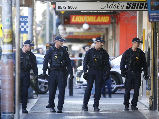 Police sweep the area for evidence on Friday. Picture: John Appleyard