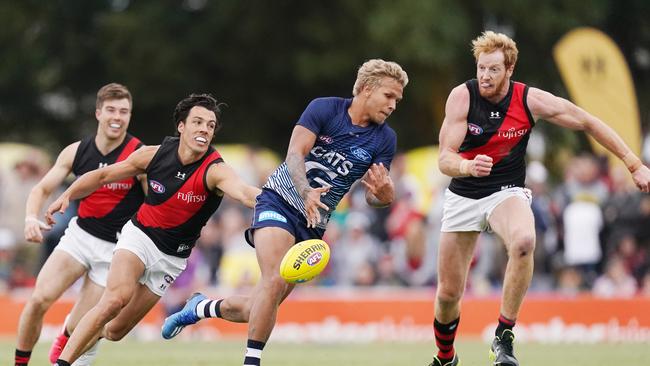 Dylan Shiel gets a hand in to halt a charging Quinton Narkle on Monday.