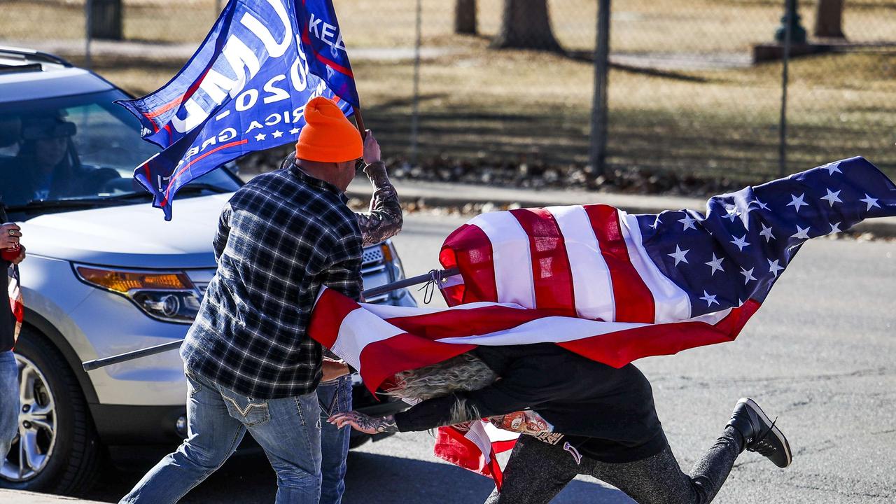 A driver, right, exits her car and attacks a Donald Trump supporter, left, next to the Colorado State Capitol after the supporter started to write on her vehicle window on January 6, 2021. Picture: Michael Ciaglo/Getty Images/AFP.