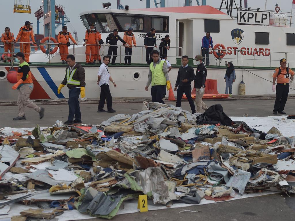 Indonesian people examining debris of the ill-fated Lion Air flight JT 610 in Jakarta. Picture: AFP