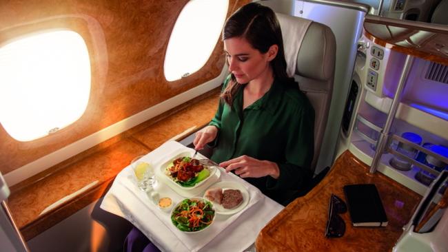 A passenger tucks in to a meal in business class aboard Emirates. Photo supplied