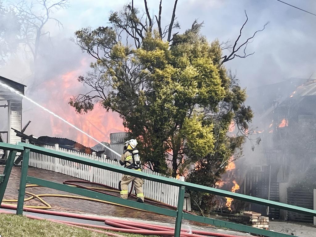 Fire crews are battling multiple house fires in Evelyn Street in Grange. Photo: Anthony Reginato.