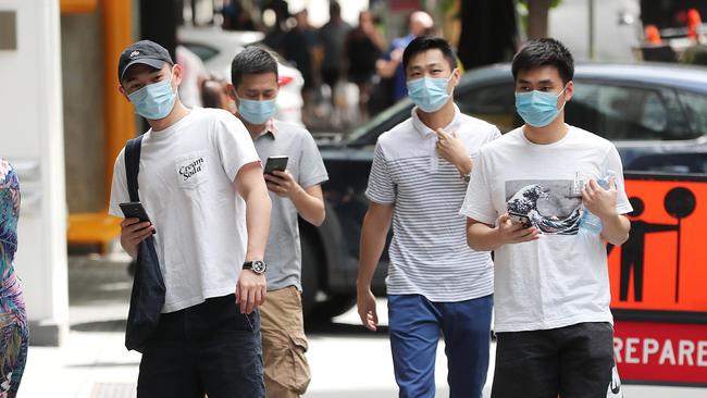 People in Brisbane CBD wearing masks. Pic Peter Wallis