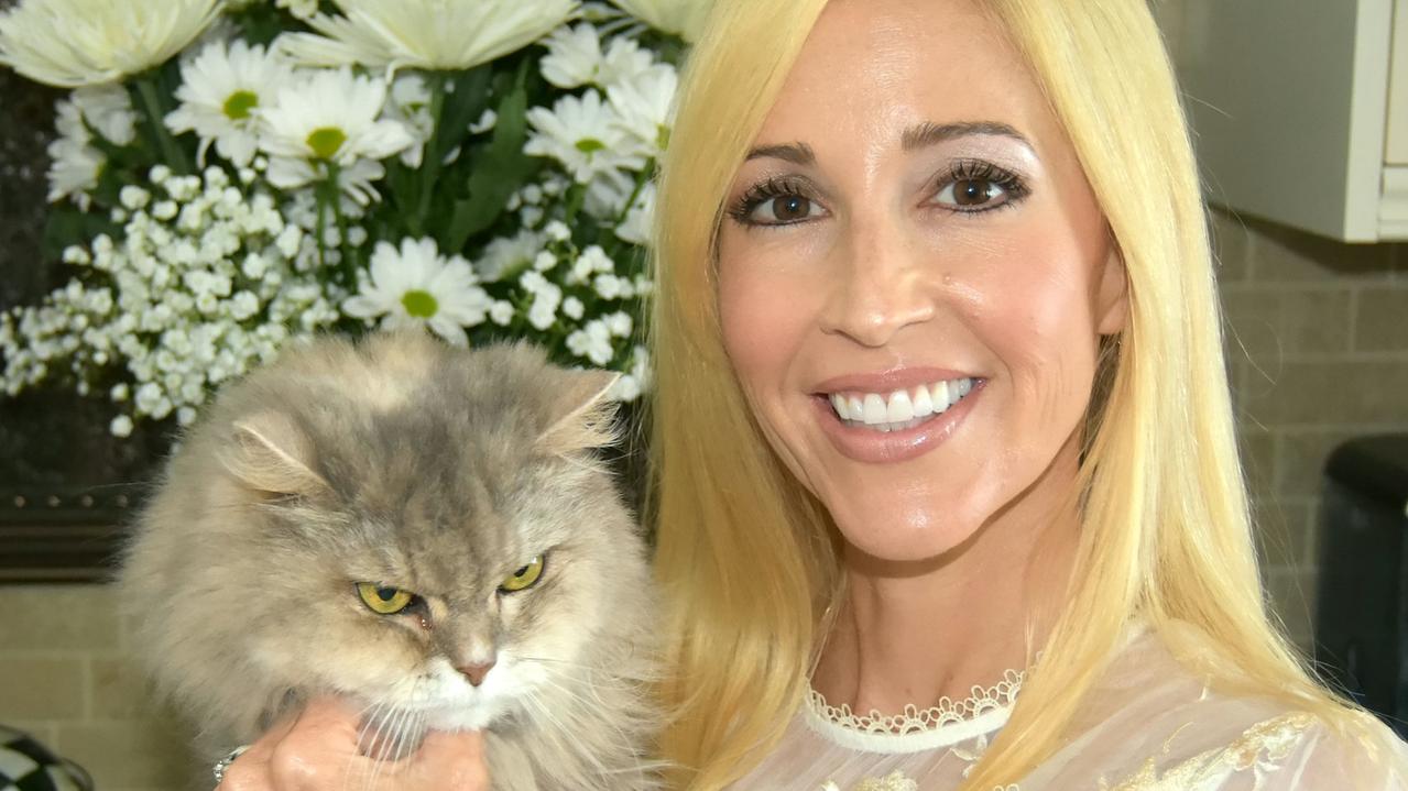 ONE TIME WEB USE ONLY - FEE APPLIES FOR REUSE -  EXCLUSIVE: Couple Bryan and Ashley Bullerdick, 43 and 41 respectively, paid $25,000 to clone their cat Cinnabun - who theyâ€™d had since they were newlyweds. A couple paid a cool $25,000 to clone their beloved cat which had been with them since they were newlyweds. Bryan and Ashley Bullerdick decided to duplicate rescue cat Cinnabun when the feline was nearing its 19th birthday.The couple had hoped that the original puss would meet the genetic twin but sadly it passed away before its clone, also named Cinnabun, arrived. Incredibly, the new Cinnabun sleeps in exactly the same spot that the original Cinnabun used to slumber, on top of Ashleyâ€™s pillow. 26 Jun 2019 Pictured: Ashley Bullerdick with the orginal Cinnabun. Photo credit: Bryan Bullerdick /SWNS.COM / MEGA TheMegaAgency.com +1 888 505 6342 (Mega Agency TagID: MEGA453254_010.jpg) [Photo via Mega Agency]  Picture: SWNS/Mega