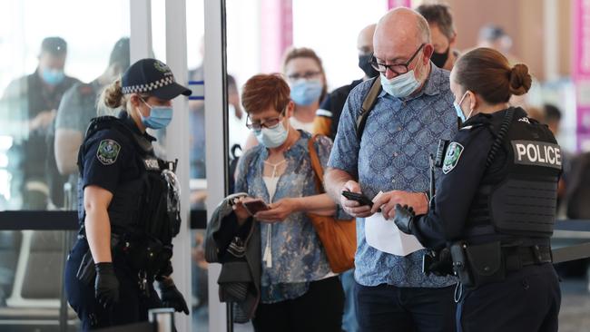 Passengers arriving from Melbourne are checked by security at Adelaide Airport. Picture: David Mariuz