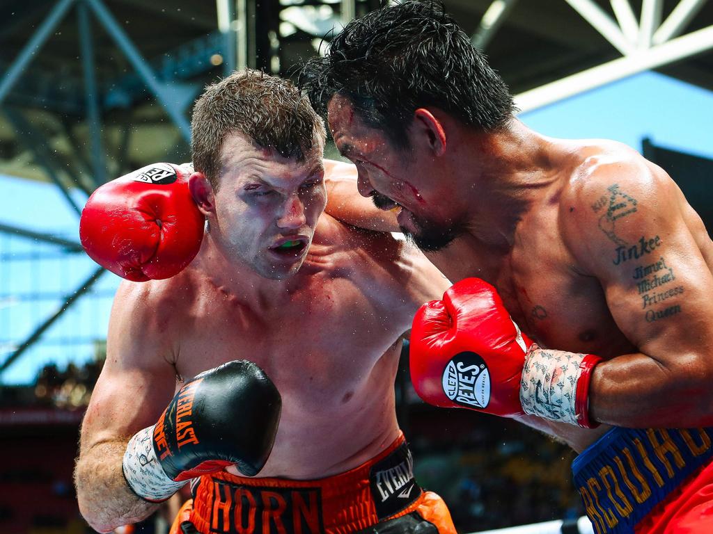 (FILES) This file photo taken on July 2, 2017 shows Manny Pacquiao of the Philippines fighting Jeff Horn of Australia (L) during their World Boxing Organization bout at Suncorp Stadium in Brisbane. Manny Pacquiao on September 3, 2017 said he still wanted a rematch with Jeff Horn after the Filipino boxing hero pulled out of their scheduled bout in Australia later his year. / AFP PHOTO / PATRICK HAMILTON / -- IMAGE RESTRICTED TO EDITORIAL USE - STRICTLY NO COMMERCIAL USE --