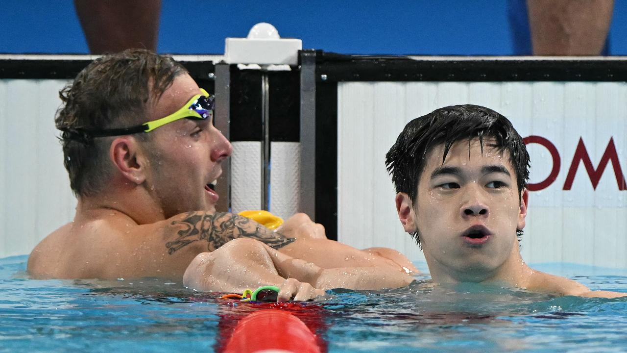 China's Pan Zhanle (R) celebrates next to Australia's Kyle Chalmers after winning the final of the men's 100m freestyle swimming event during the Paris 2024 Olympic Games at the Paris La Defense Arena in Nanterre, west of Paris, on July 31, 2024. (Photo by Jonathan NACKSTRAND / AFP)