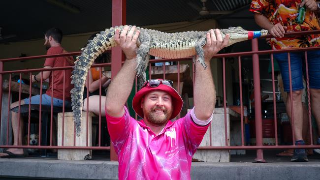 Jordan Gartshore with ‘Soft Croc’ at the Berry Springs Croc Races celebrating the Melbourne Cup Picture: Glenn Campbell