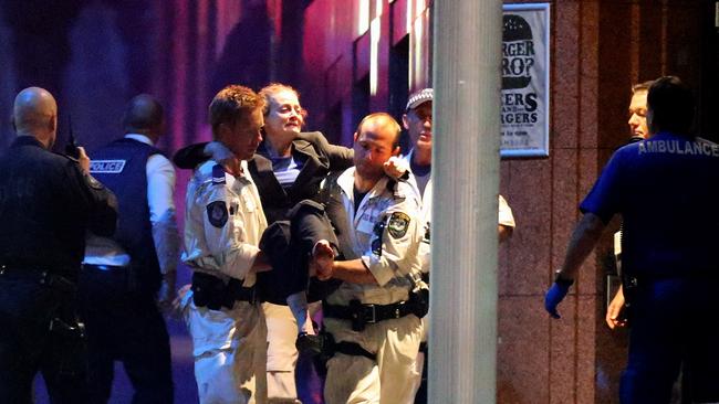 Marcia Mikhael is carried out of the Lindt Cafe by police. Picture: Joosep Martinson/Getty Images