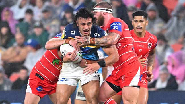 Tino Fa’asuamaleaui charges into the Dragons’ defence. Picture: Bradley Kanaris/Getty Images