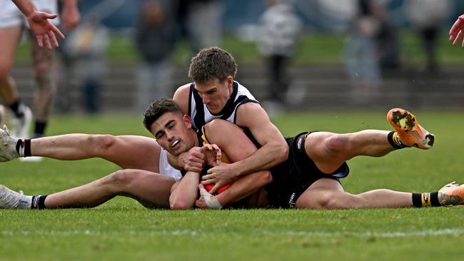 Bundoora’s Joel Lamotte wraps up Kai Kearns of Heidelberg. Picture: Andy Brownbill