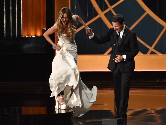 Actress Sofia Vergara is helped onto the stage by Television Academy CEO Bruce Rosenblum.