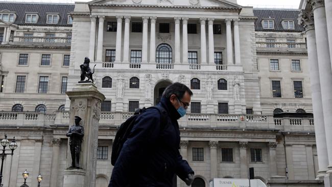 A man wearing protective face mask walks past the Bank of England in the City of London. Picture: AFP