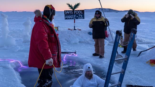 An earlier Davis team prepares the Winter Solstice dip in Antarctica. The freezing swim forms part of important celebrations to mark the wid-winter point. Picture: Tiarnan Colgan / AAD