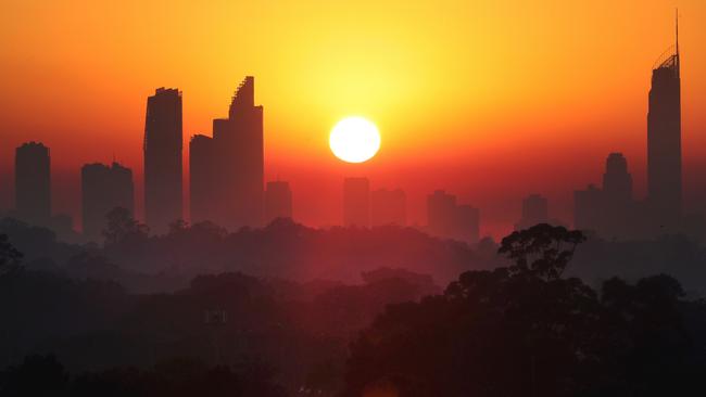 A smoke haze from southeast Queensland's bushfires descended on the Gold Coast this morning, blanketing the high rises and making for a spectacular sunrise. Picture: Glenn Hampson