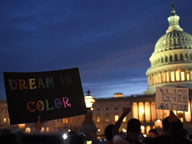 Protesters hold signs outside the Capitol in Washington, DC. Picture: AFP