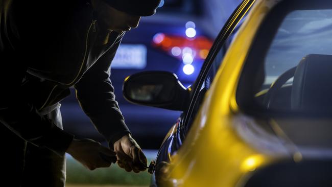 Car thief stealing a car. iStock.