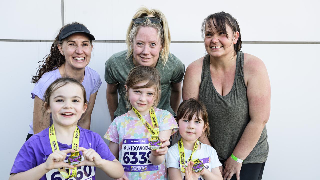 Showing their Runway Mile finisher medals are (front, from left) Maisie Williams, Phoebe Masters and Annabelle with their mums Sharni Masters, Pamela Farquharson and Ashleigh at the Toowoomba Marathon events at Wellcamp Airport, Saturday, May 3, 2025. Picture: Kevin Farmer