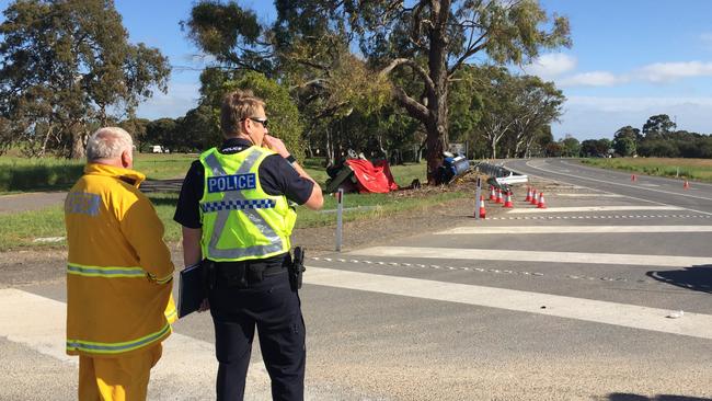 A CFS volunteer and police officer near the horrific scene. Photo: Gretel Sneath