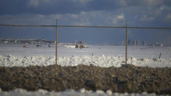 A Delta plane on its roof after crashing on landing at Toronto Pearson Airport