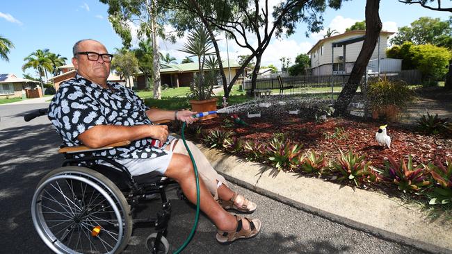 Ken Lidster watering the traffic island in front of his house.