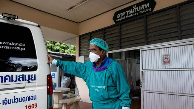 A mortuary worker prepares to move the body of Australian cricket player Shane Warne as it is transported from Koh Samui Hospital mortuary. Picture: AFP