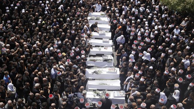 Mourners at a funeral for 10 of the victims of the weekend’s rocket attack on a soccer pitch in the Golan Heights. Picture: Amir Levy/Getty Images