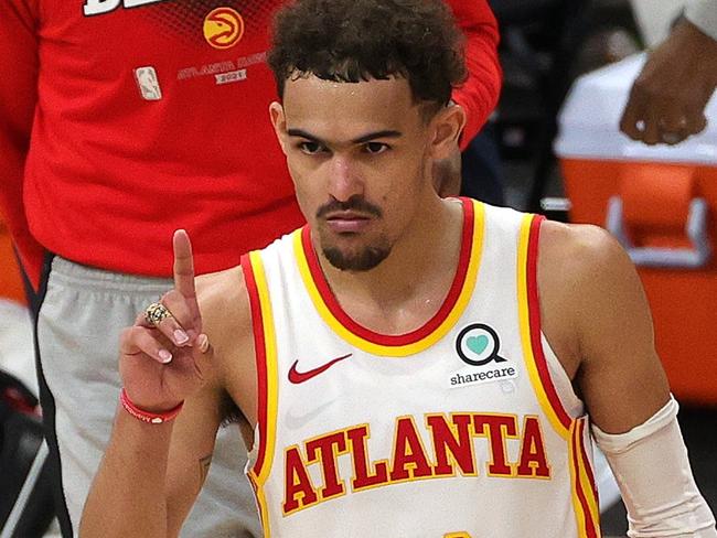 MILWAUKEE, WISCONSIN - JUNE 23: Trae Young #11 of the Atlanta Hawks celebrates a win against the Milwaukee Bucks in game one of the Eastern Conference Finals at Fiserv Forum on June 23, 2021 in Milwaukee, Wisconsin.   Stacy Revere/Getty Images/AFP == FOR NEWSPAPERS, INTERNET, TELCOS & TELEVISION USE ONLY ==