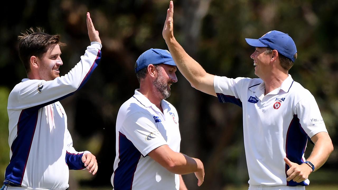 Nick Murray (left) celebrates a wicket with Banyule teammates. Picture: Andy Brownbill