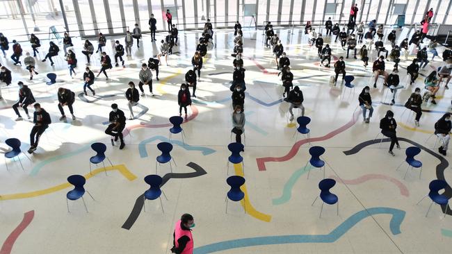 Year 12 students patiently await their Pfizer vaccinations at Sydney Olympic Park in the city’s west on Monday. Picture: Getty Images