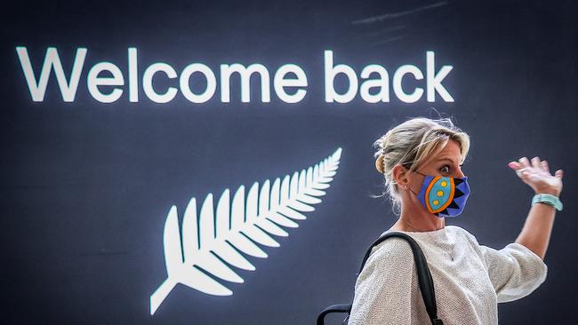 A passenger reacts upon arrival from New Zealand at Sydney International Airport, but it won’t be until the end of next year that tourist operators can expect bigger numbers. Picture: AFP