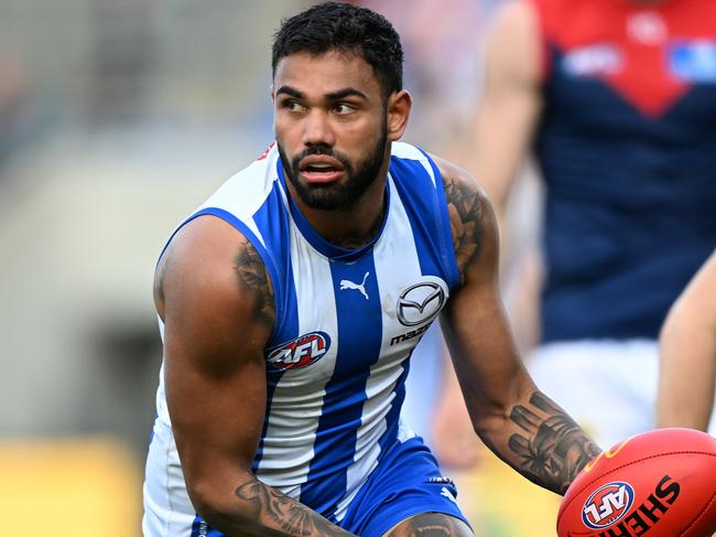 HOBART, AUSTRALIA - AUGUST 06: Tarryn Thomas of the Kangaroos runs the ball during the round 21 AFL match between North Melbourne Kangaroos and Melbourne Demons at Blundstone Arena, on August 06, 2023, in Hobart, Australia. (Photo by Steve Bell/Getty Images)