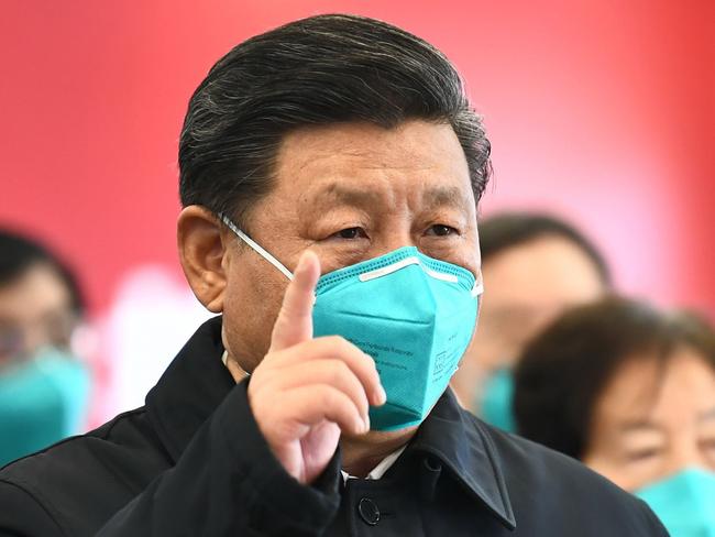 This photo released on March 10, 2020 by China's Xinhua News Agency shows Chinese President Xi Jinping wearing a mask as he GESTURES to a coronavirus patient and medical staff via a video link at the Huoshenshan hospital in Wuhan, in China's central Hubei province on March 10, 2020. (Photo by Xie Huanchi / XINHUA / AFP) / China OUT - Hong Kong OUT - Japan OUT - Germany OUT - United States OUT - United Kingdom OUT / -----EDITORS NOTE---- RESTRICTED TO EDITORIAL USE - ONE TIME USE - MANDATORY CREDIT "AFP PHOTO/XINHUA / XIE HUANCHI" - NO MARKETING NO ADVERTISING CAMPAIGNS - DISTRIBUTED AS A SERVICE TO CLIENTS - NO ARCHIVES /