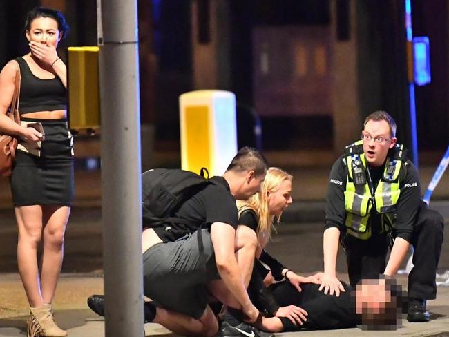 A casualty is treated on London Bridge after a white van was driven into pedestrians.