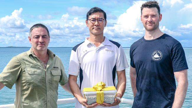 Marine Archaeologist David Steinberg and Dr Mattew Carter present Takenobu Hamaguchi with sand from the vicinity of the Japanese WWII wreck of I-124 submarine as a dive expedition returns from a Heritage documentation trip. Picture: Glenn Campbell