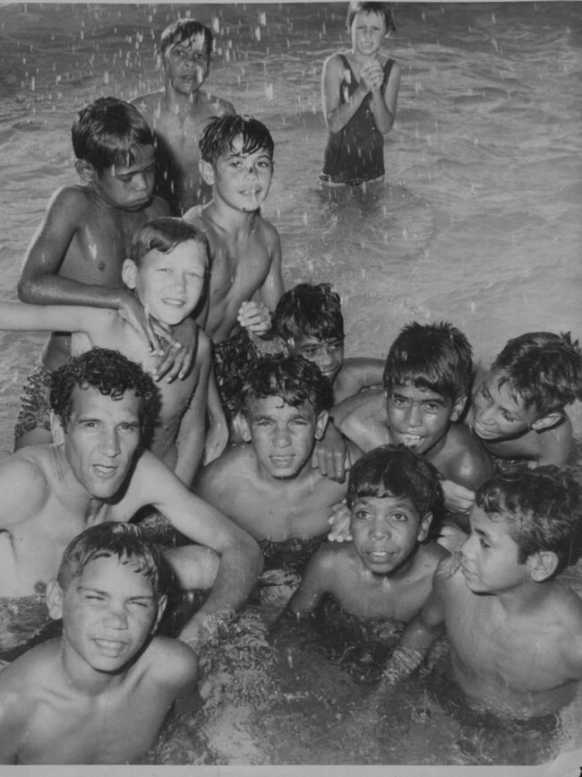 Charles Perkins, left centre, makes a splash at the newly desegregated Moree pool in February 1965. Picture: Ann Curthoys