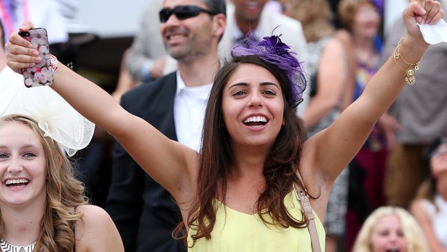 Melbourne Cup Day 2014 at Flemington Racecourse. Punters cheer on the horses during the last race. Picture: Mark Stewart